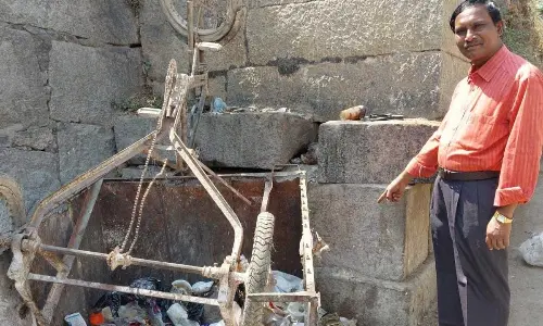 Historian Mynaa Swamy at Sri Krishnadevaraya’s inscription found in the garbage at the North Gate of Penukonda Fort