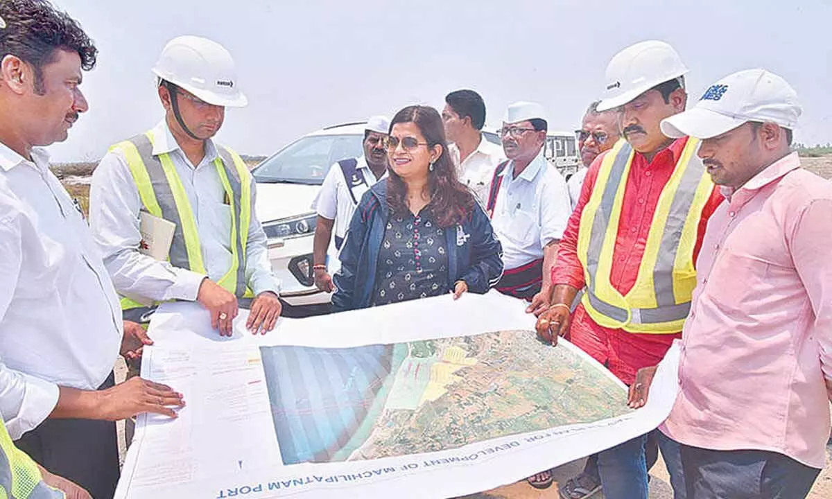 Krishna district Joint Collector Dr Aparajitha Singh going through port construction area map in Machilipatnam on Wednesday