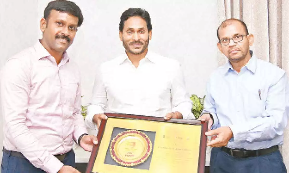 Agriculture special commissioner Harikiran and agriculture special secretary Gopal Krishna Dwivedi show the award received by the state for implementation of YSR Free Crop Insurance Scheme to Chief Minister Y S Jagan Mohan Reddy at his camp office in Tadepalli on Friday