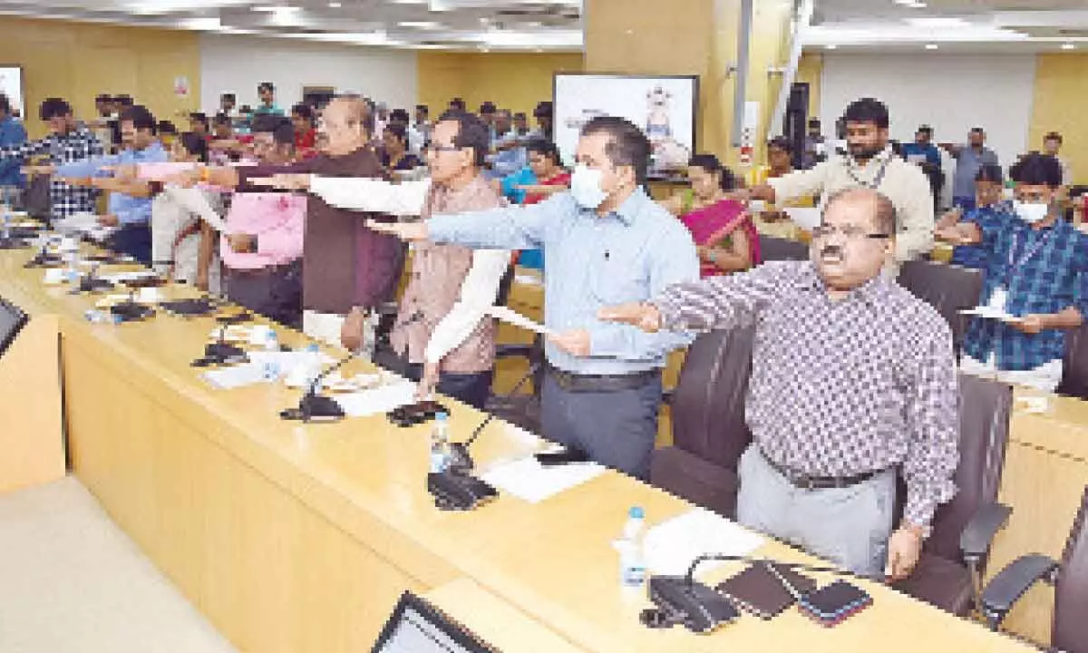 Senior officials taking a pledge as the National Civil Services Day was observed at the Secretariat in Velagapudi on Friday