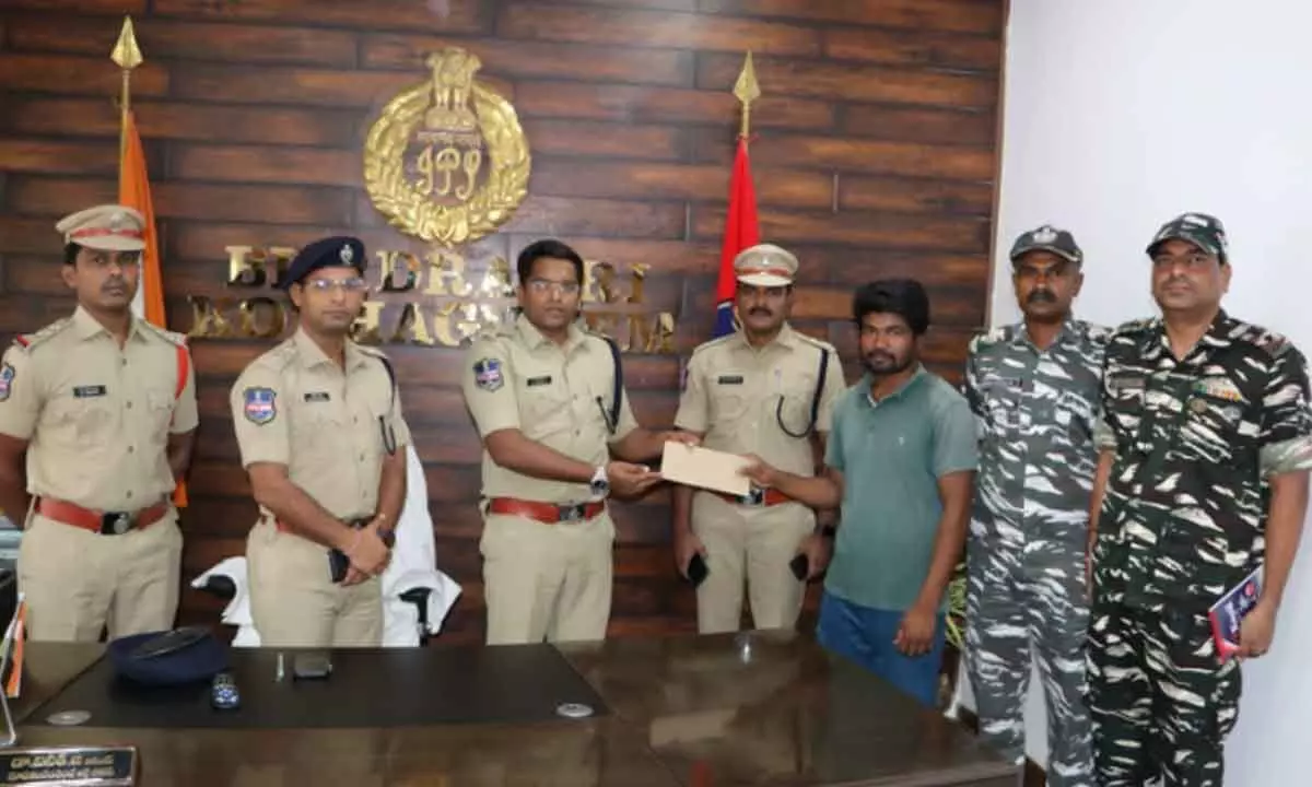 SP Dr G Vineeth handed over money to surrendered Maoist in his office in Kothagudem on Tuesday