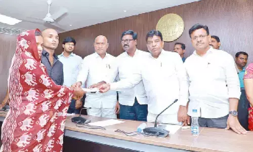 Minister for Transport Puvvada Ajay Kumar distributing cheques to Cheemalapadu cylinder  blast victims’ families  in Khammam on Tuesday
