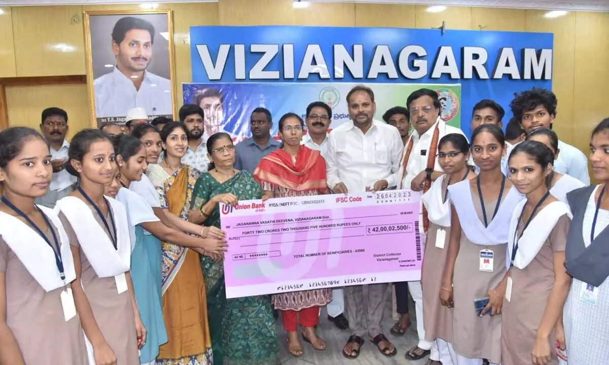 Collector S Nagalakshmi, ZP Chairman Chinna Srinu handing over cheques to students in Vizianagaram on Wednesday