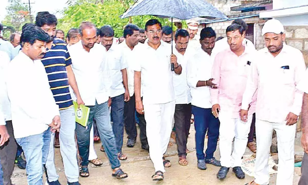 Agriculture Minister Singireddy Niranjan Reddy inspecting the CC road  constructed at a cost of Rs 2.5 crore in Wanaparthy district on Wednesday