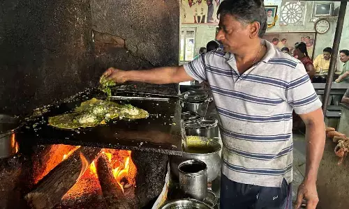 Hotel Owner Sanka Ramu preparing Pesarattu-Upma in the hotel.