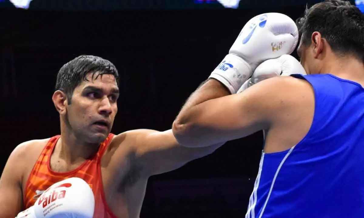 India’s Narender Berwal lands  a punch on  the opponent
