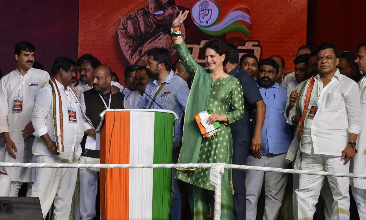 AICC general secretary Priyanka Gandhi waves at supporters during a public meeting at Saroornagar stadium in Hyderabad on Monday