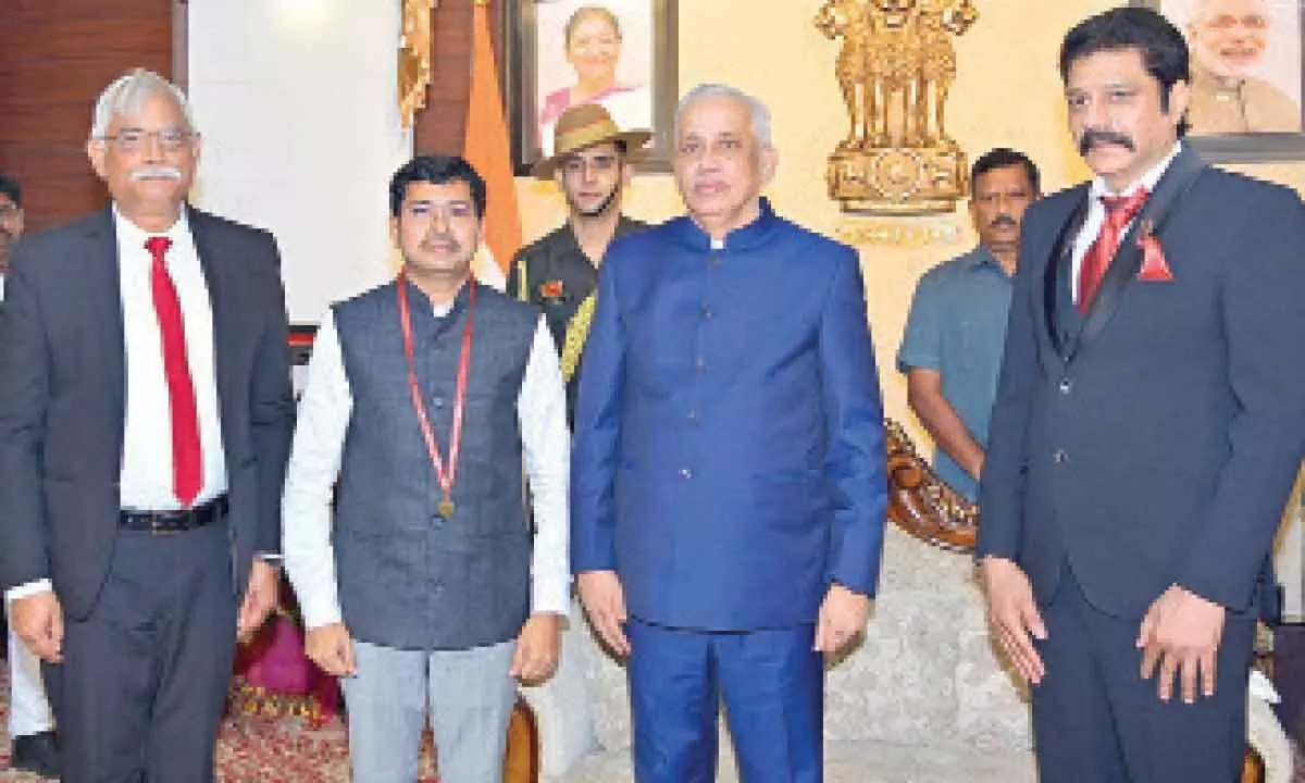 Vizag Collector receives gold medal from Governor S Abdul Nazeer