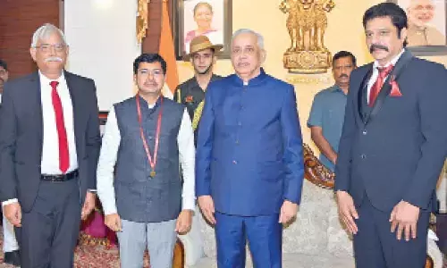 Vizag Collector receives gold medal from Governor S Abdul Nazeer