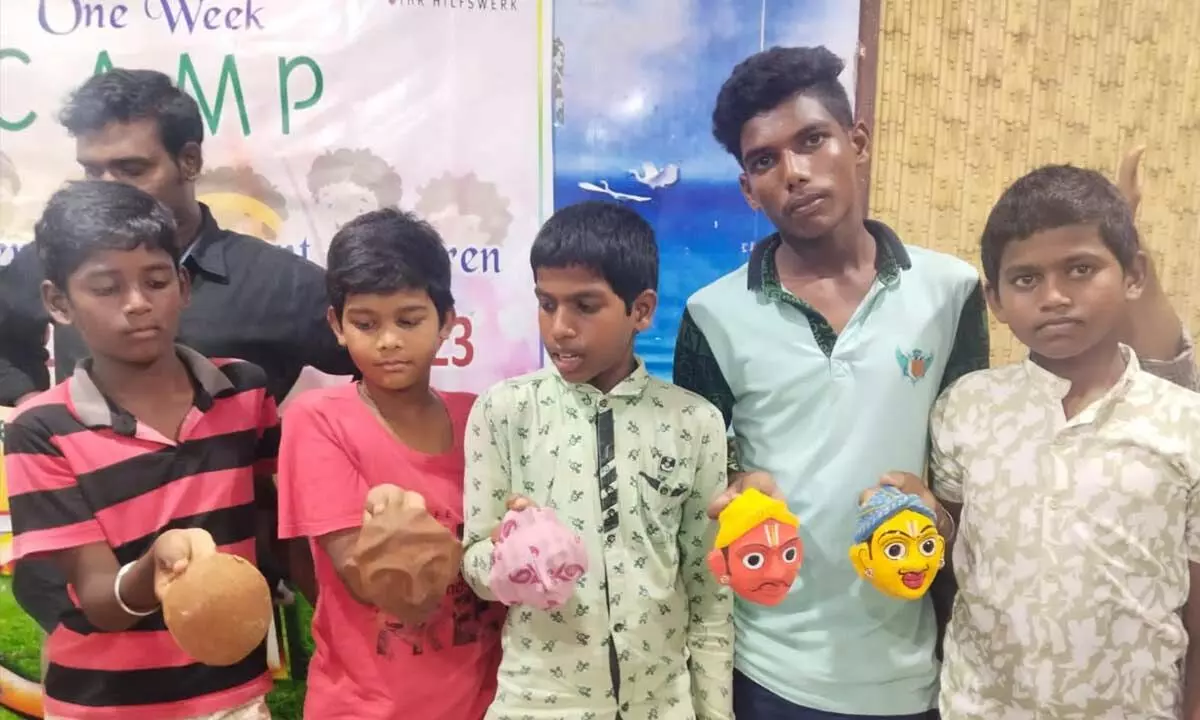 Children showing the masks, which they have prepared, at Vasavya Children’s Home at Kanuru on Tuesday