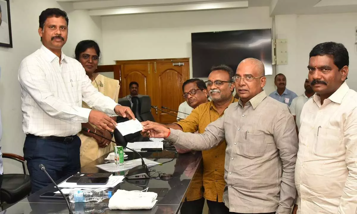 Vijayawada rural panchayat secretaries handing over a cheque for Rs 1 lakh donation to Collector S Dilli Rao in Vijayawada on Tuesday