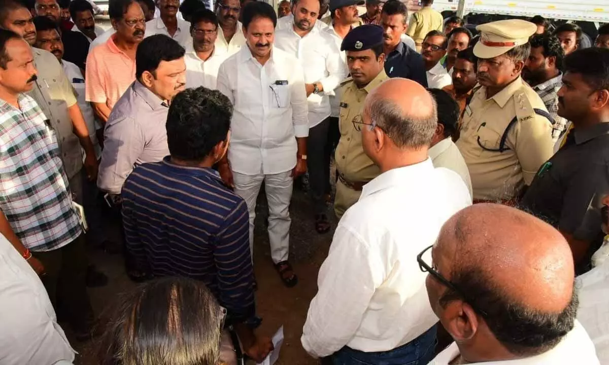 Rajya Sabha Member Mopidevi Venkata Ramana Rao and district Collector Ranjit Basha reviewing arrangements for the CM’s visit in Nizampatnam on Sunday