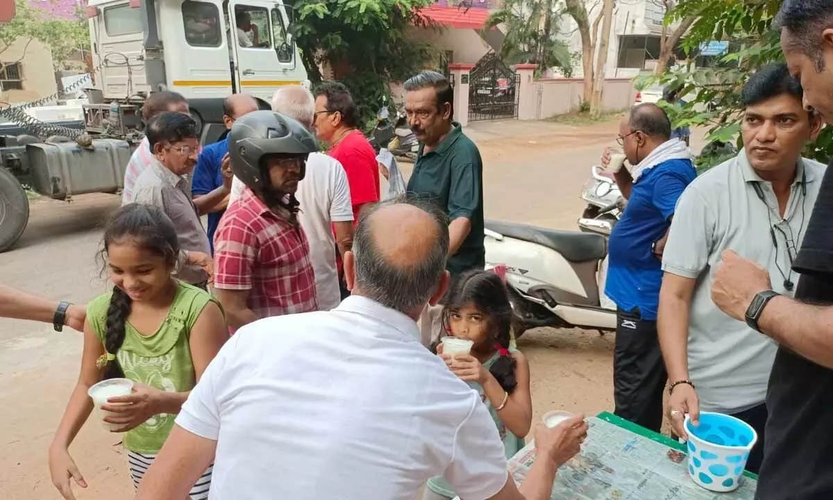 Club members distributing glasses of buttermilk to passersby in Visakhapatnam on Sunday