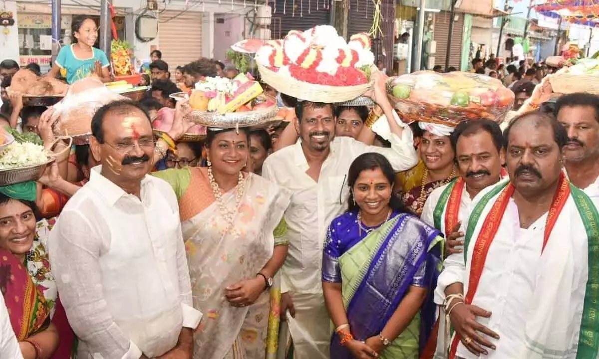 Tourism Minister R K Roja along with her family members carrying Sare on her head to present to Goddess Gangamma in Tirupati on Sunday. MLA Karunakar Reddy is also seen.