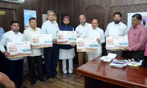 Telangana Home Minister Mohammad Mahmood Ali releases the posters of the TUWJF national conference