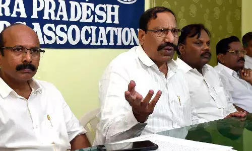 Andhra Pradesh Lorry Owners Association general secretary Y V Eswara Rao and members addressing a press conference at association office in Vijayawada on Tuesday