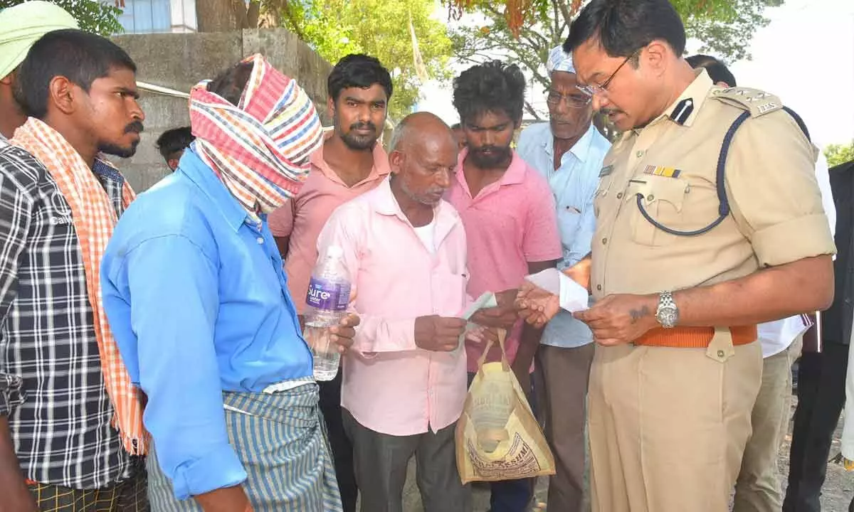 Commissioner of Police A V Ranganath checking the records of paddy procurement at a rice mill near Mucharla Nagaram Cross Road in Hanumakonda district on Wednesday