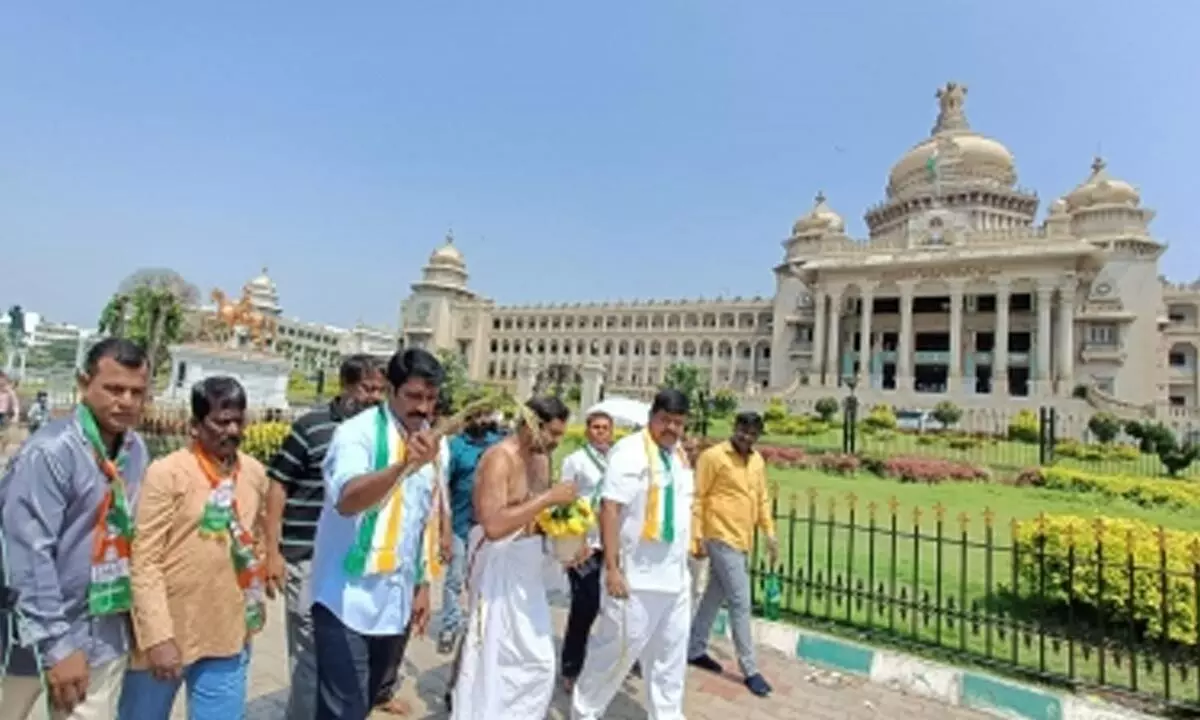 Congress workers sprinkle Gau mutra near Karnataka Assembly