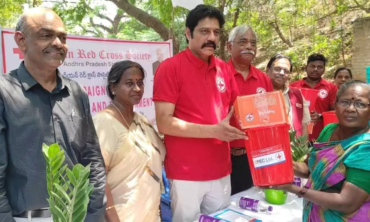 Red Cross Chairman A Sridhar Reddy distributing hygiene kits to the public in Vijayawada on Tuesday