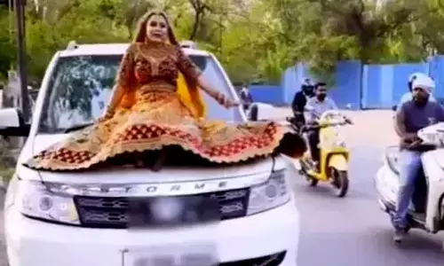 A Bride In Up Sitting On Top Of A Moving SUV