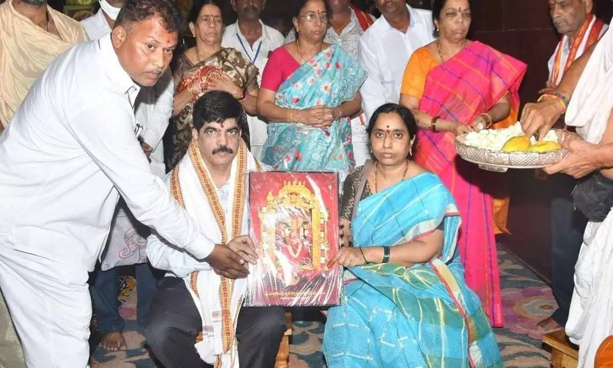 Temple officials presenting Goddess Durga portrait to High Court Judge Justice V Srinivas at Sri Kanaka Durga temple atop Indrakeeladri on Wednesday