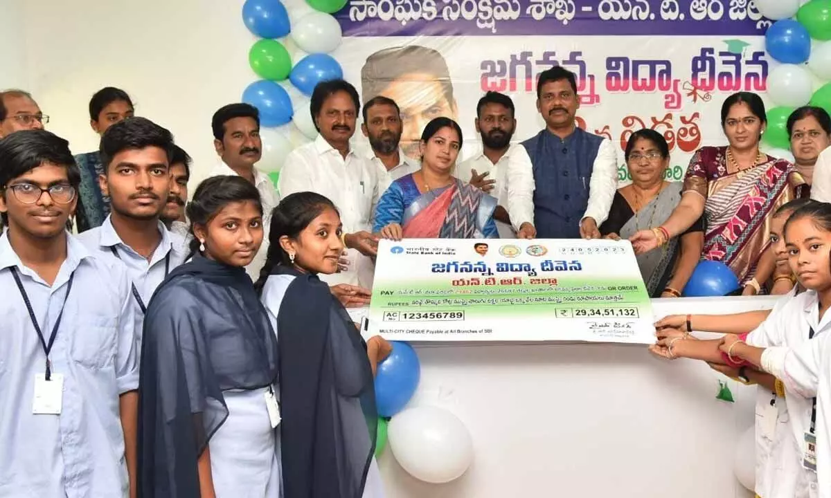 NTR district Collector S Dilli Rao handing over the specimen cheque to the beneficiaries at the Collectorate in  Vijayawada on Wednesday