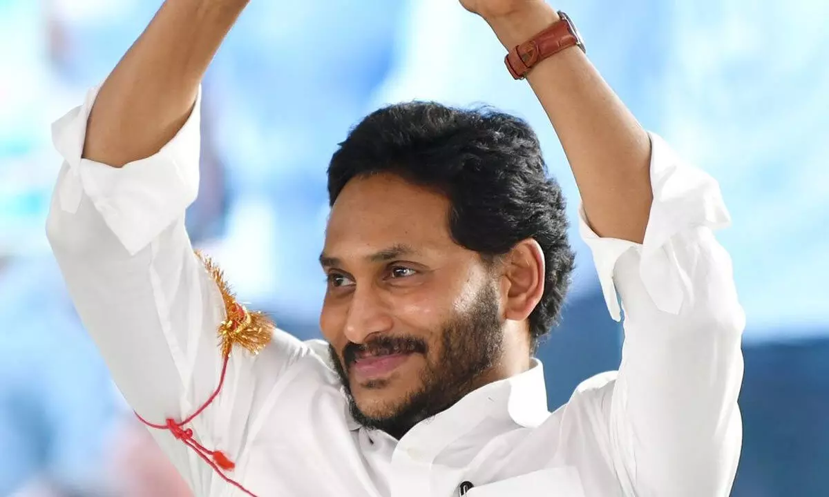 Chief Minister Y S Jagan Mohan Reddy greets the people while addressing a public meeting after crediting money under Jagananna Vidya Deevena at Kovvur in East Godavari district on Wednesday