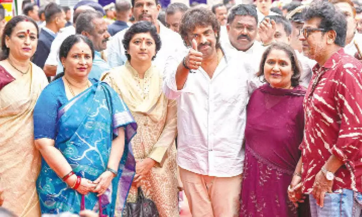 Newly-inducted minister Madhu Bangarappa (C) with his sister Geetha Shivarajkumar and Kannada actor Shiva Rajkumar during the swearing-in ceremony of newly-inducted cabinet ministers at  Raj Bhavan, in Bengaluru on Saturday