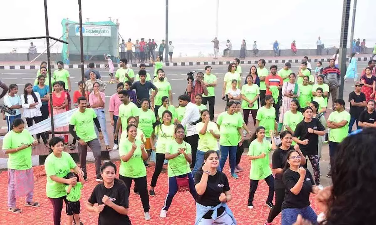 Runners  breaking into a jig as a part of the Whitathon organised at RK Beach in Visakhapatnam