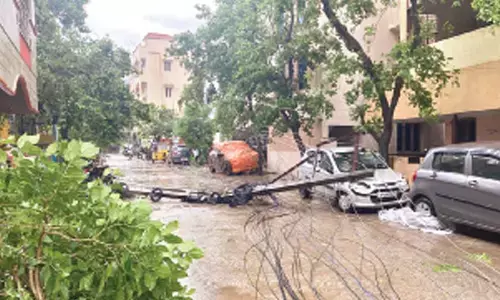 Electric pole fell on a car at Subba Reddy Nagar of Tirupati rural mandal
