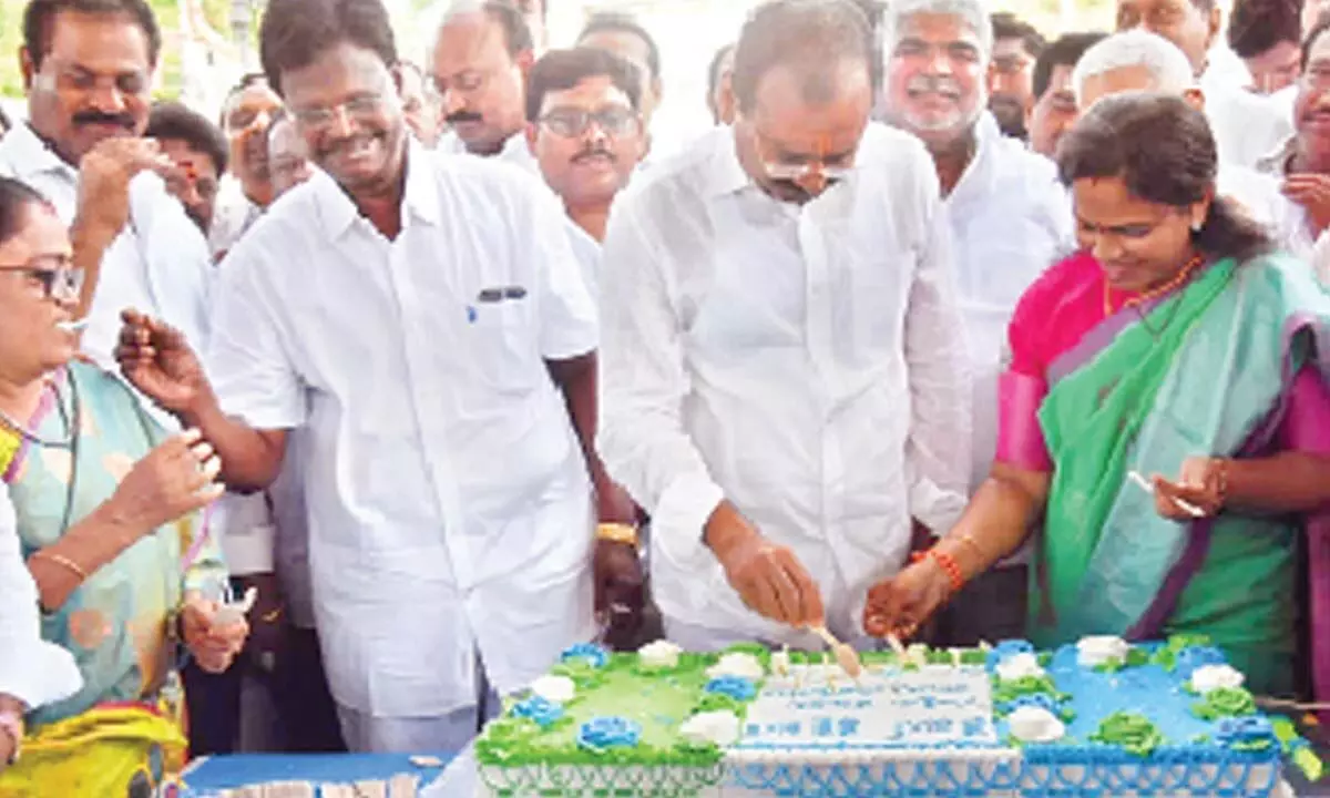 MLA Bhumana Karunakar Reddy cutting a cake in the presence of MLC Dr Cipai Subramanyam, Mayor Dr R Sirisha and others in Tirupati on Tuesday to mark the completion of four years of YSR rule in the State