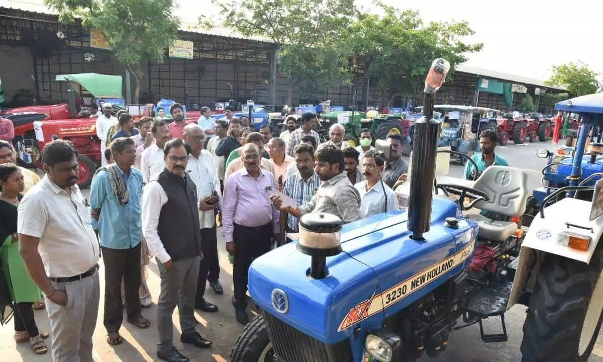 District Collector M Venugopal Reddy inspecting the tractors ready for distribution, at Guntur Mirchi Yard on Wednesday