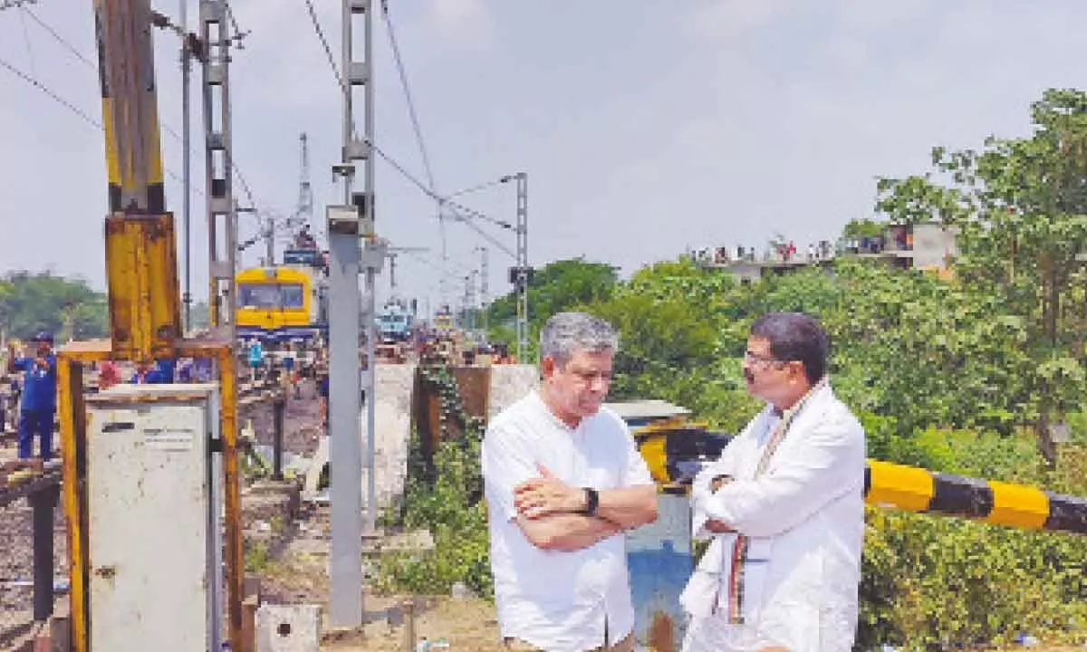 Union Ministers Ashwini Vaishnaw and Dharmendra Pradhan take stock of the ongoing restoration work at the triple train accident site, at Bahanaga Bazar in Balasore on Sunday