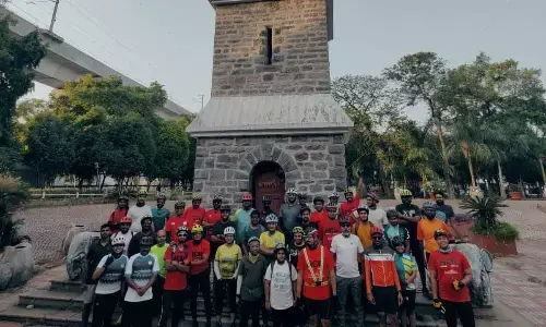 Cyclists in awe of Secunderabad Clock Tower