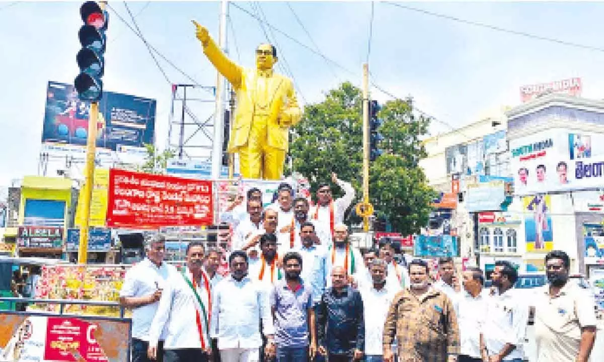 Congress party city convener MD Javeed along with party leaders protest at Dr Ambedkar statue for extended support to Wrestlers issues at Khammam on Monday