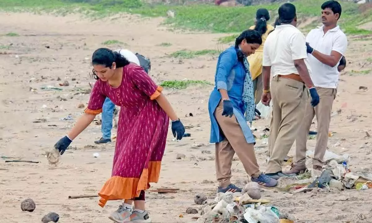 Participants at the beach clean-up activity organised by Andhra University in  Visakhapatnam on Thursday