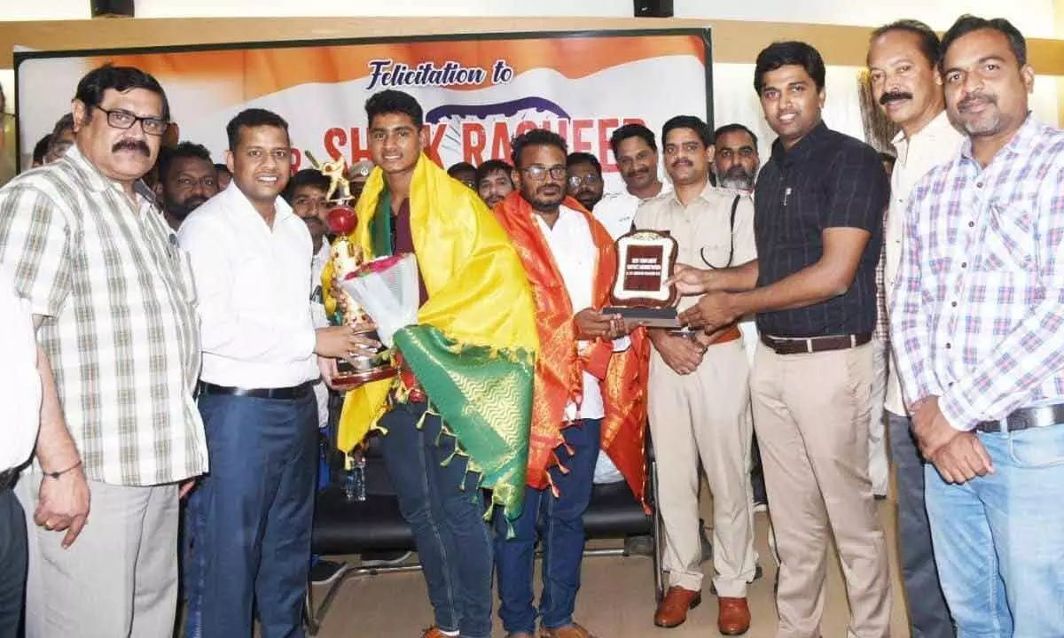 Konaseema district Collector Himanshu Shukla felicitating Shaik Rasheed, vice-captain of India Under-19 men’s cricket team, in Amalapuram on Thursday