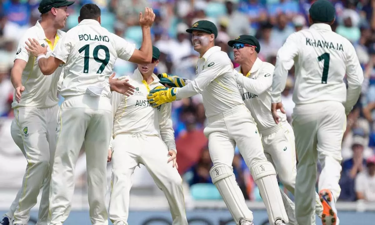 Australias Scott Boland (19), celebrates with teammates after taking the wicket of Indias Virat Kohli caught by Australias Steven Smith on the fifth day of the ICC World Test Championship final between India and Australia at The Oval cricket ground in London on Sunday