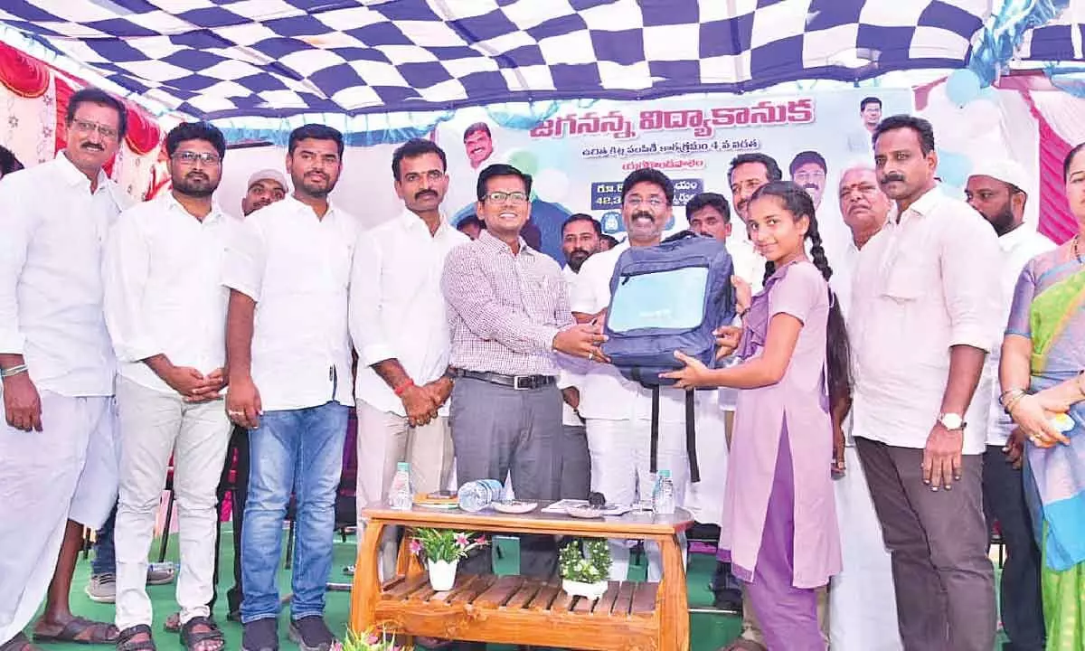 MAUD Minister Dr A Suresh, district Collector AS Dinesh Kumar and DEO P Ramesh distributing Jagananna Vidya Kanuka Kit to a student at ZPHS Yerragondapalem on Monday