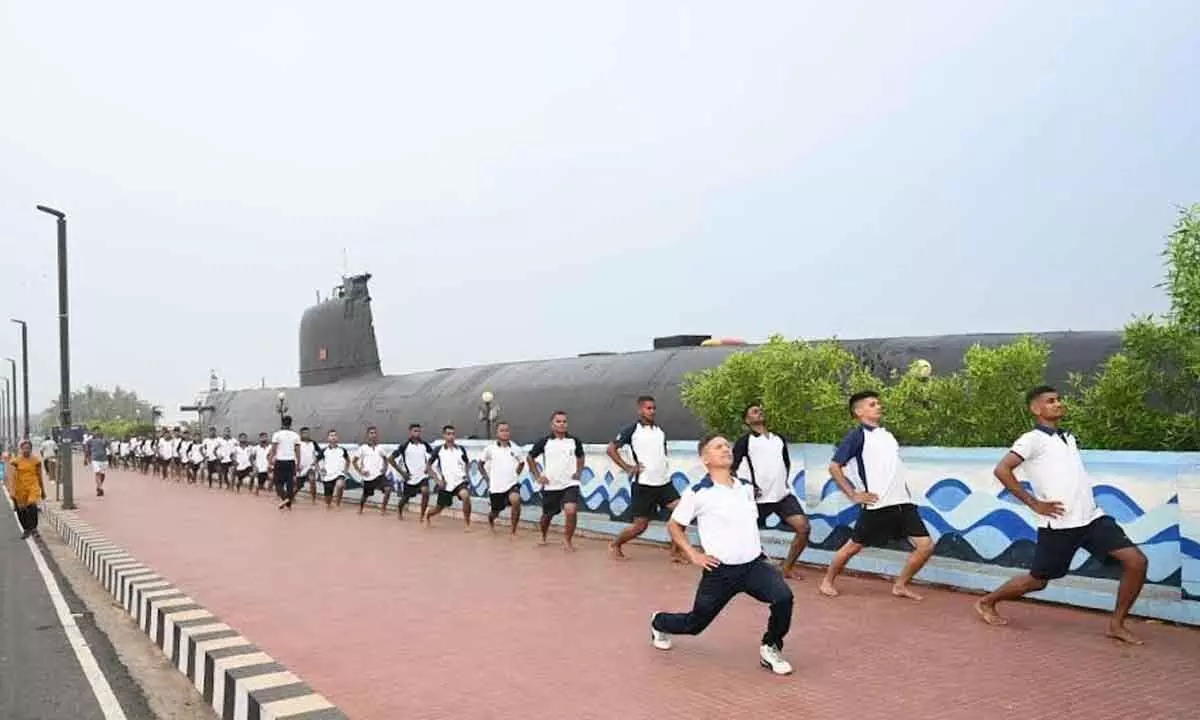 Naval personnel taking part in a yoga session near INS Kursura Submarine Museum at RK Beach on Tuesday