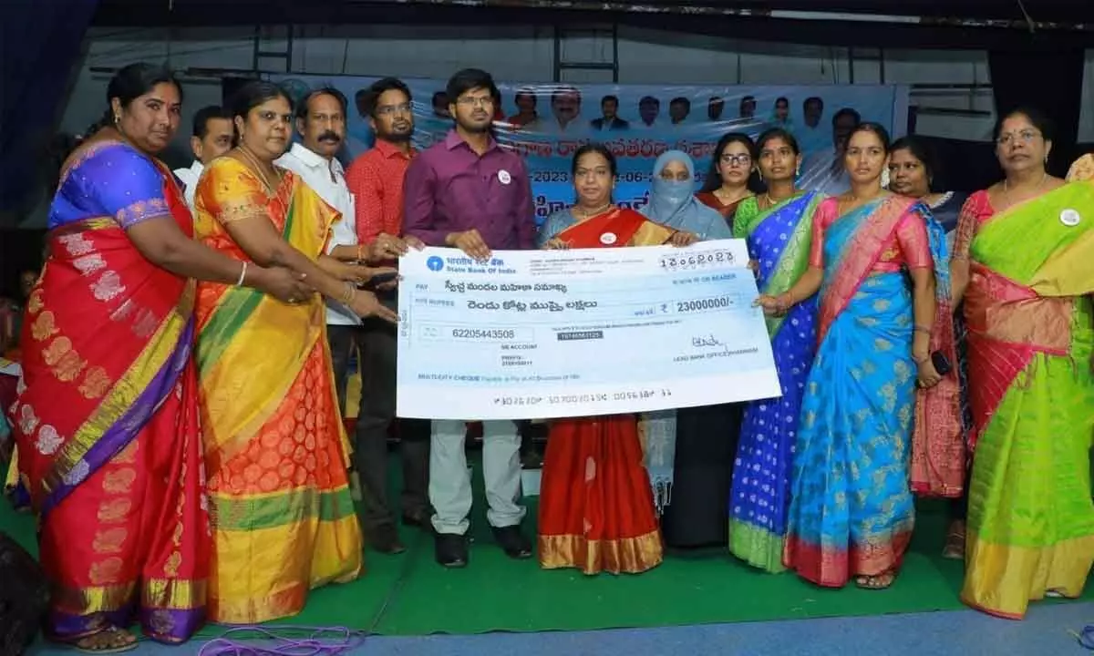 Collector VP Gautham distributing cheques to women groups in Khammam on Tuesday