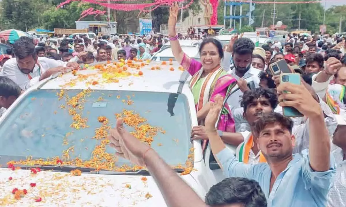 NRI Hanumandla Jhansi Reddy waves her hand to her supporters in Palakurthi constituency on Thursday