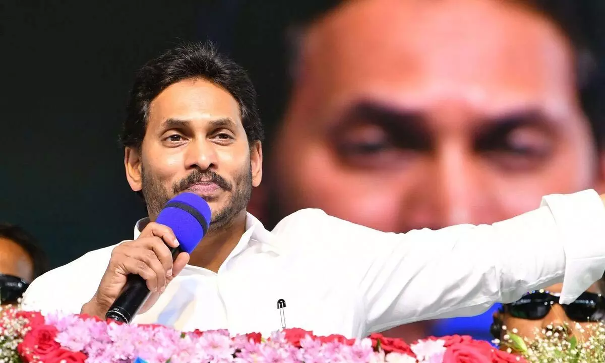 Chief Minister Y S Jagan Mohan Reddy addressing the a public meeting after handing over TIDCO houses near Gudivada in Krishna district on Friday