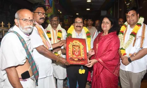 Priests presenting Goddess Durga portrait to Supreme Court Judge Justice Prashant Kumar Mishra and his spouse at Durga temple in Vijayawada on Friday. High Court Acting Chief Justice Akula Venkata Sesha Sai is also seen.
