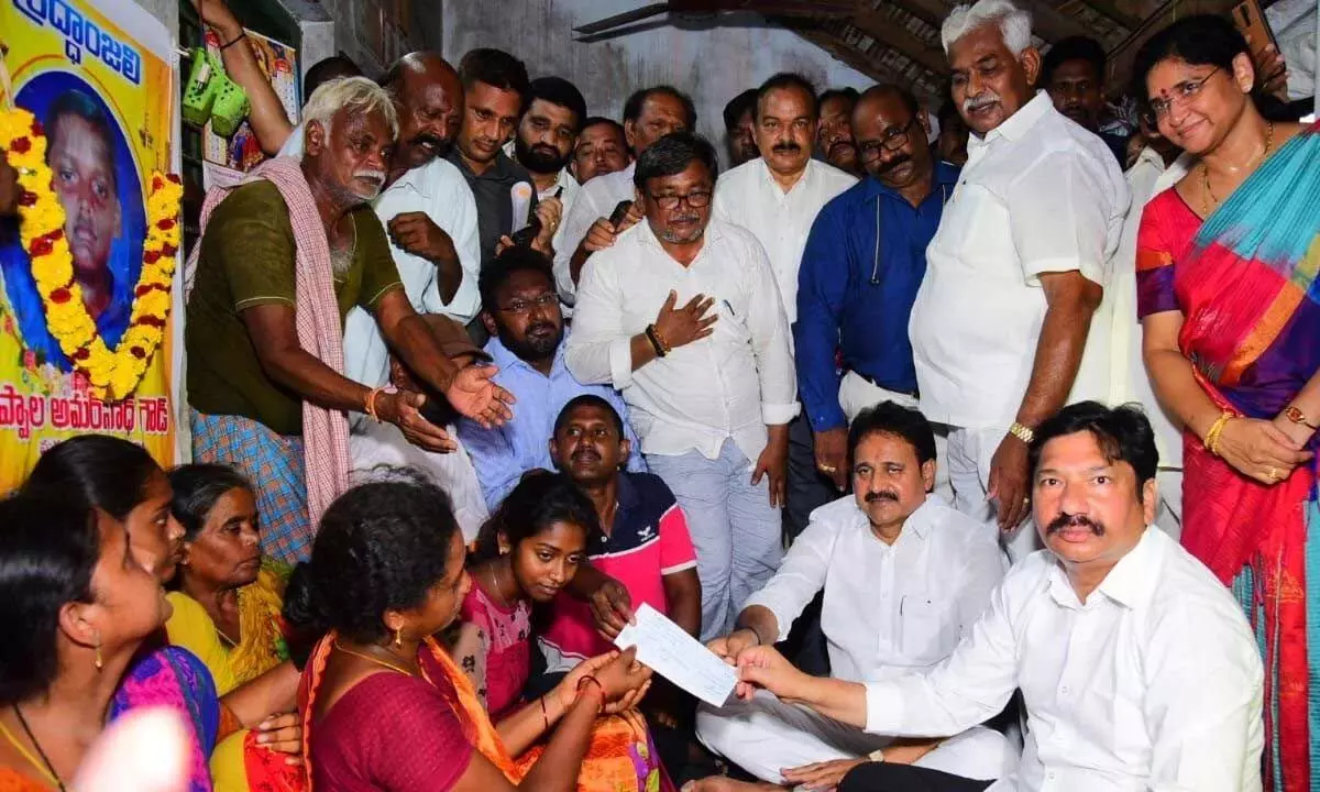 Housing Minister Jogi Ramesh and MP Mopidevi Venkata Ramana Rao giving a cheque and house site patta to the family members of murdered boy Amarnath at Uppalavaripalem on Sunday