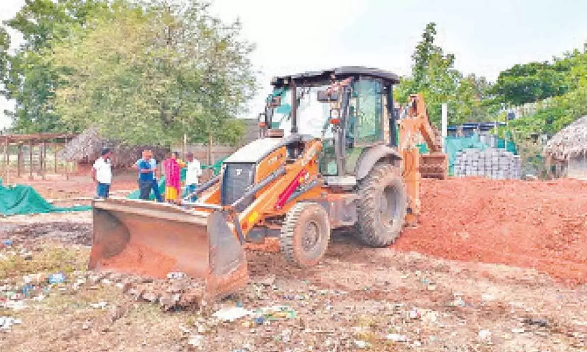 The officials removing encroachments from the Lord Rama temple lands in Purushothapatnam in Andhra Pradesh on Tuesday