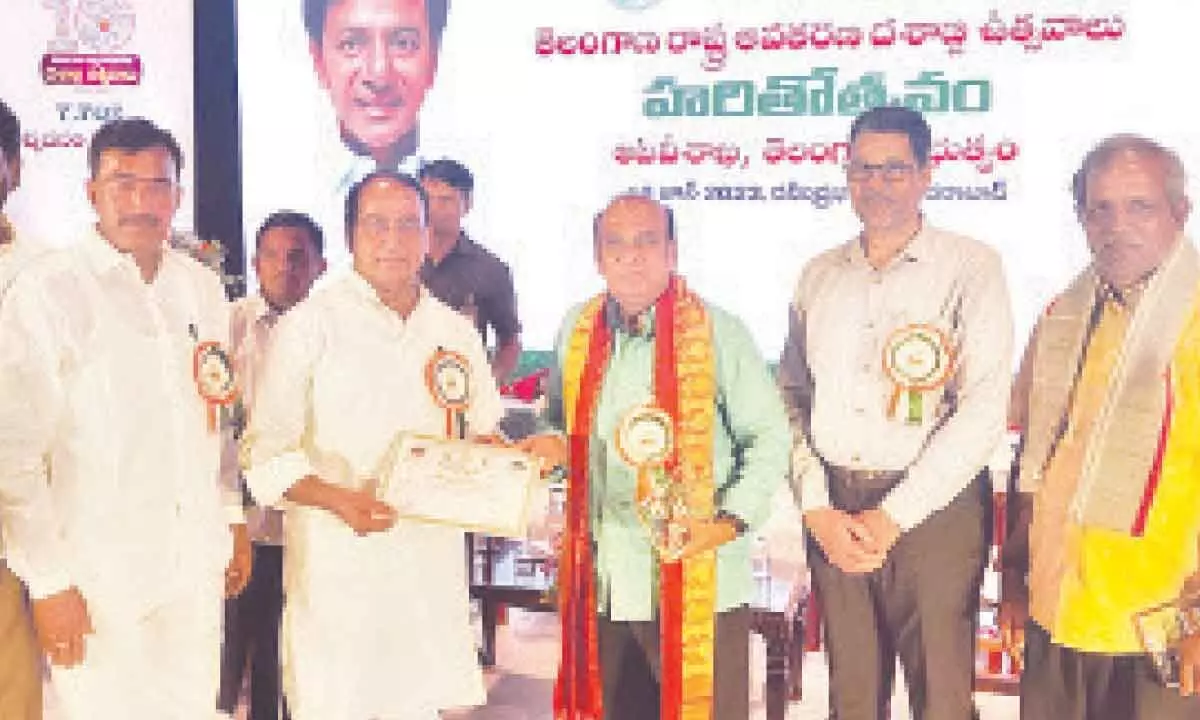 Forest Minister A Indrakaran Reddy presenting Haritha Haram Award to Dr. Golla Bhupathi Rao in Hyderabad on Monday
