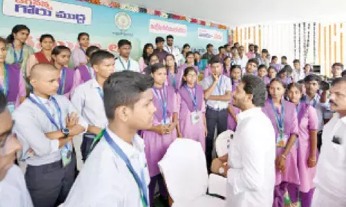 Chief Minister Y S Jagan Mohan Reddy interacts with students at Jagananna Animutyalu Awards programme on Tuesday