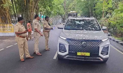 Police distributing pamphlets on safety norms to be followed by motorists on Tirumala ghat road at the 7th mile on the first ghat road on Wednesday