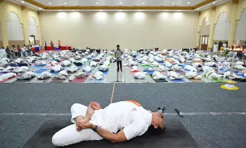 Yoga practitioners demonstrating a set of asanas at Gadiraju Palace in Visakhapatnam on Wednesday